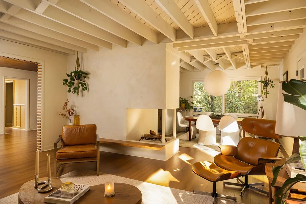 Renovated living room with vaulted beams and warm natural light