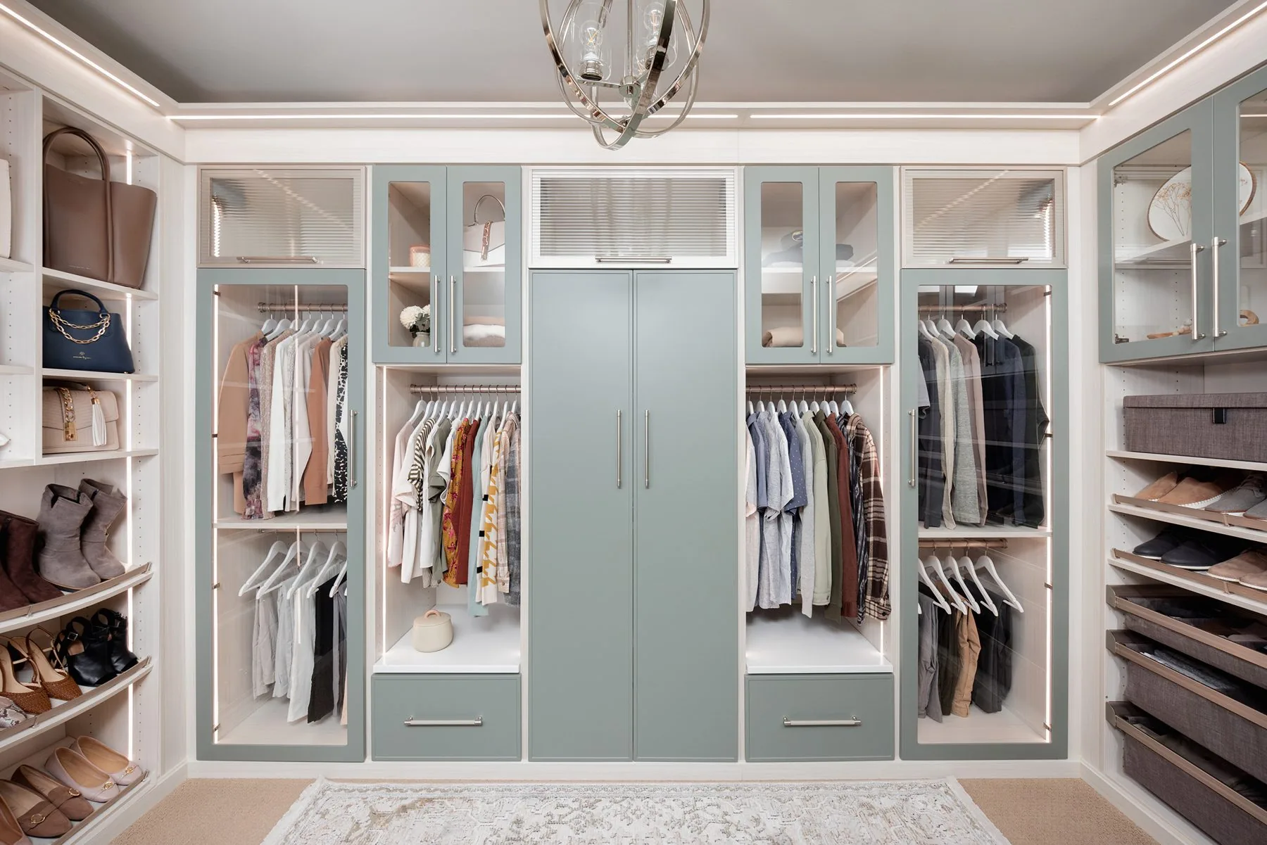 Walk-in closet system in soft sage and white with island storage