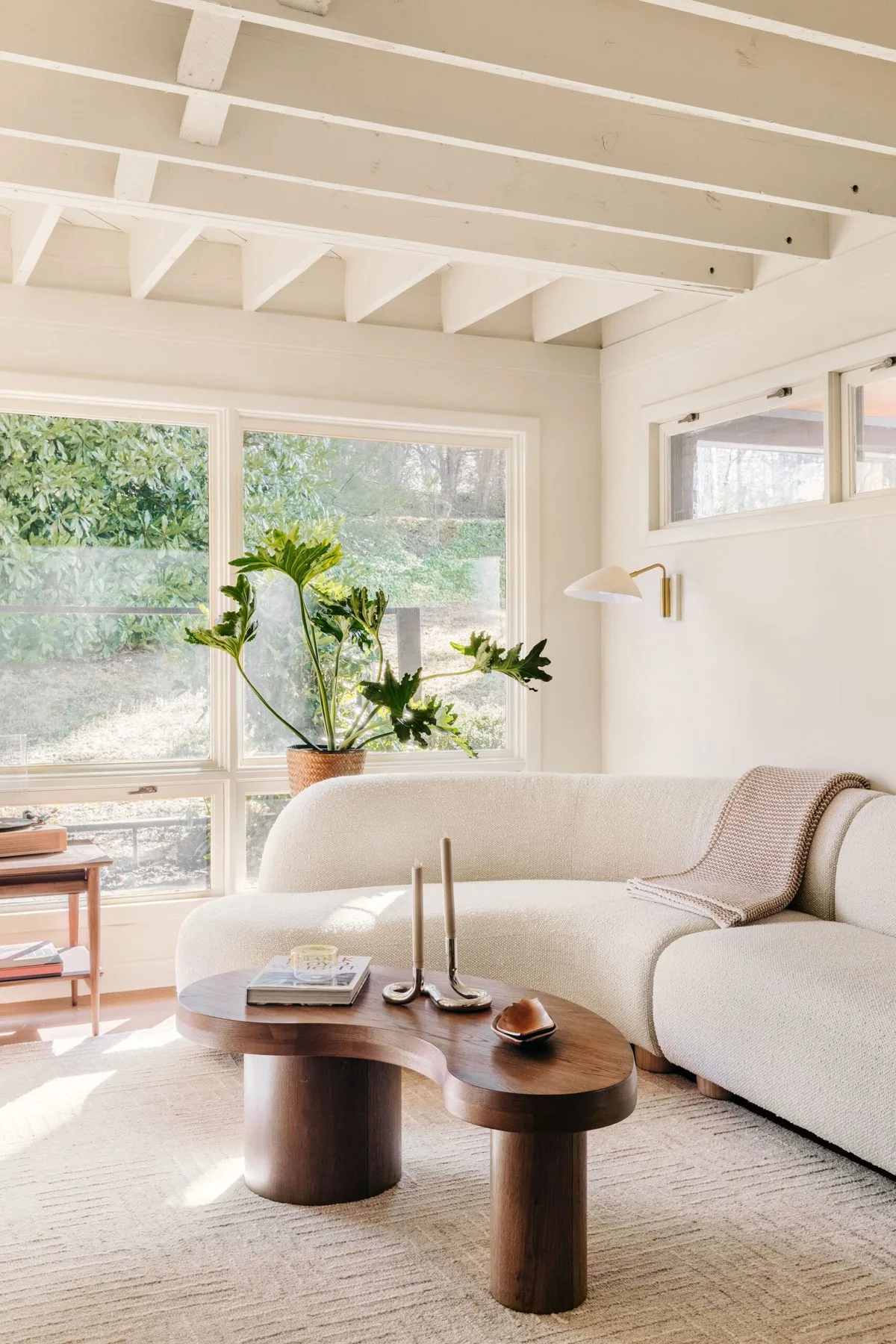 Living room with layered natural light through custom window treatments