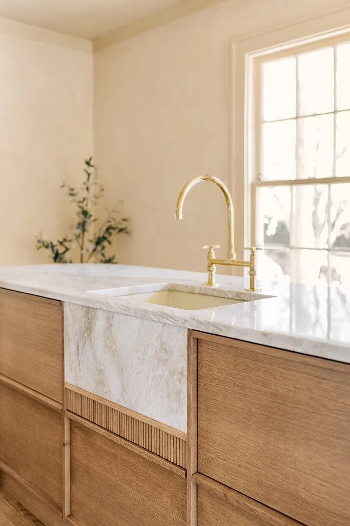 Marble vanity with a fluted wood base